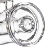 Close-up of MJ Arsenal mini dab rig base with thick clear glass footing and etched logo detail