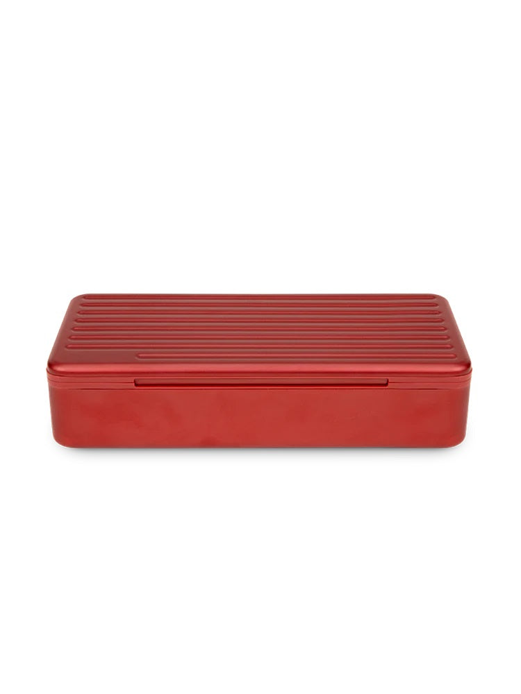 Closed Puffco Daybreak Travel Case in ridged red aluminum, compact rectangular profile photographed on white background.