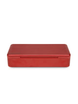 Closed Puffco Daybreak Travel Case in ridged red aluminum, compact rectangular profile photographed on white background.