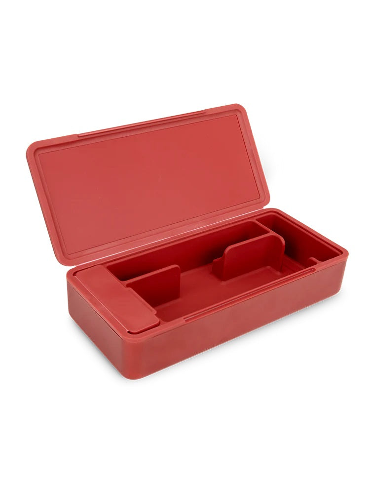 Open Puffco Daybreak Travel Case showing modular silicone dividers inside red aluminum shell, lid hinged to reveal storage.