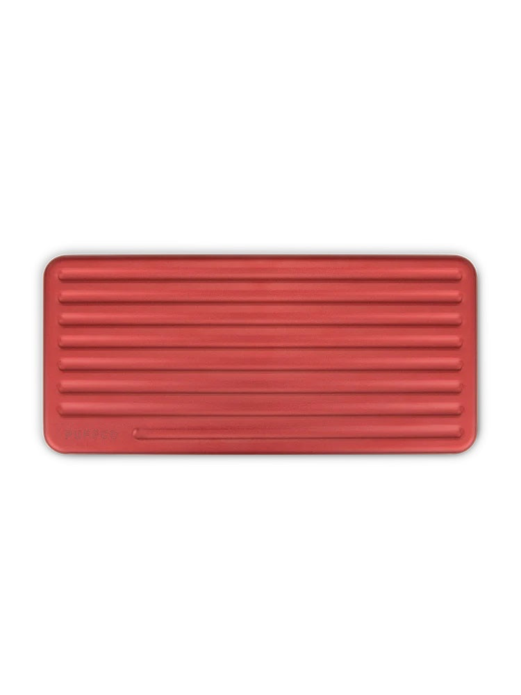 Top-down view of closed Puffco Daybreak Travel Case, slim rectangular silhouette with evenly spaced ridges across lid.