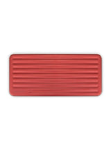 Top-down view of closed Puffco Daybreak Travel Case, slim rectangular silhouette with evenly spaced ridges across lid.