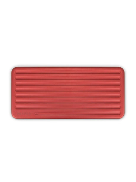 Top-down view of closed Puffco Daybreak Travel Case, slim rectangular silhouette with evenly spaced ridges across lid.