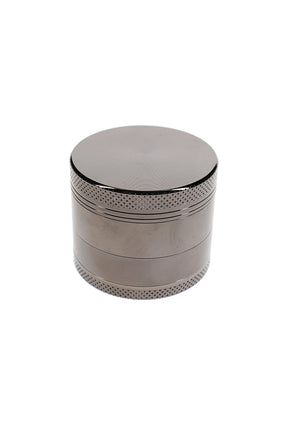 Closed silver metal herb grinder with textured grip bands and small 1.5 inch pocket-size design