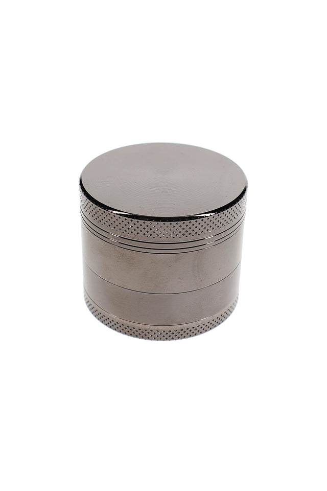 Closed silver metal herb grinder with textured grip bands and small 1.5 inch pocket-size design