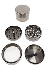 Open 4-part metal herb grinder with teeth, screen chamber, scraper, and 2 inch silver body