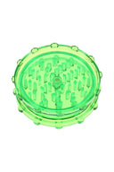 Green acrylic magnetic herb grinder with translucent body and evenly spaced grinding pegs.