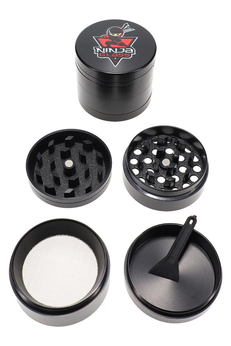 Black Ninja Glass 4-piece 40 mm herb grinder with kief screen and scraper, shown disassembled on a white background.