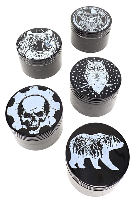 Assorted black aluminum 4-piece herb grinders showing tiger, samurai, owl, skull, and mountain bear white decal lids.
