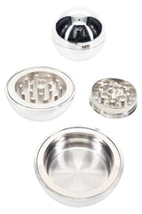 Open chrome sphere herb grinder showing metal teeth, screen section, and bottom catcher compartment