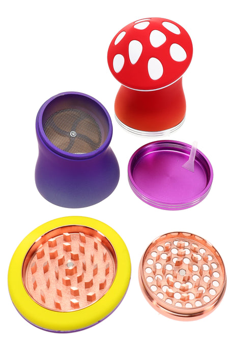 Mushroom-shaped 4-part metal herb grinder, 2¼″ zinc-alloy body with diamond teeth, mesh screen, pollen catcher, scraper and multicolor pieces displayed.
