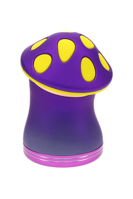 Purple and yellow mushroom metal herb grinder shown assembled, compact 2¼″ 4-part design with smooth ergonomic cap and metallic finish.
