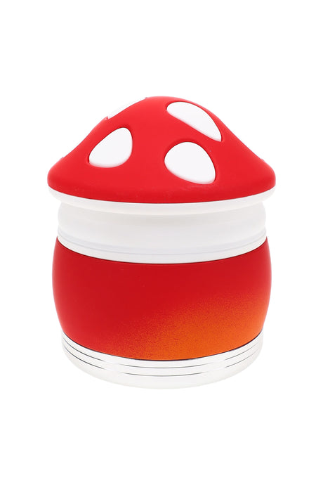 Red-and-white mushroom metal grinder assembled, compact 2¼″ 4-part body with smooth finish and windowed chamber for easy viewing.