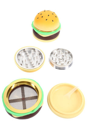Hamburger-shaped 1.75″ 4-part metal herb grinder disassembled to show teeth, mesh screen, kief catcher, and scraper tool.