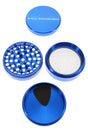 Blue Cali Crusher O.G. 2.5″ grinder opened to show sharp teeth, pollen screen, and included kief scraper.