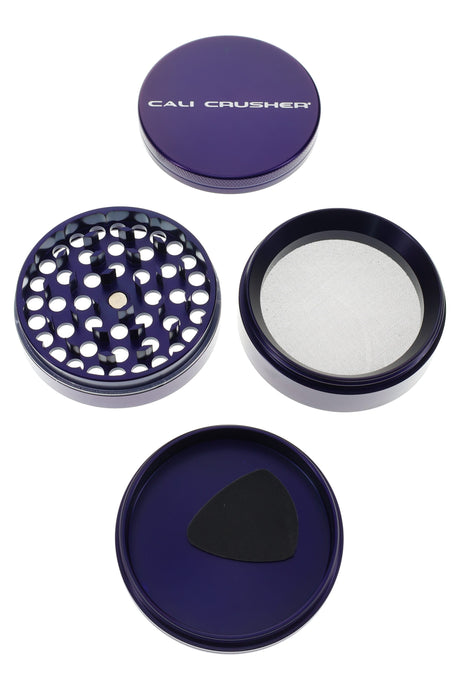 Purple Cali Crusher O.G. 2.5″ 4-part grinder opened, showing magnetic lid, teeth, and pollen screen.