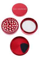 Red Cali Crusher O.G. 4-piece metal grinder opened to show uniform teeth and included pollen scraper.