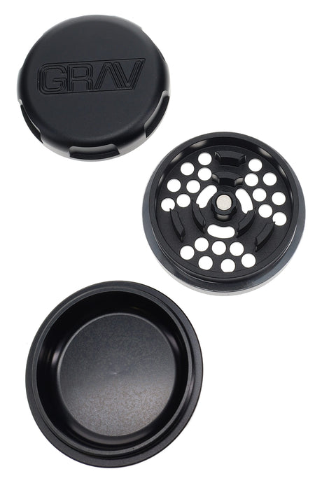 Black GRAV 3-piece grinder opened to show precision teeth plate and deep storage dish with magnetic lid.