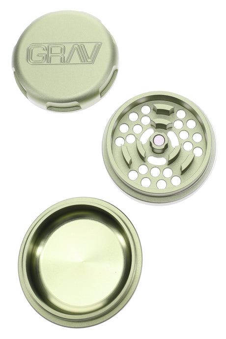 Green GRAV 2.75″ aluminum 3-piece grinder components displayed—toothed plate and roomy catch chamber.