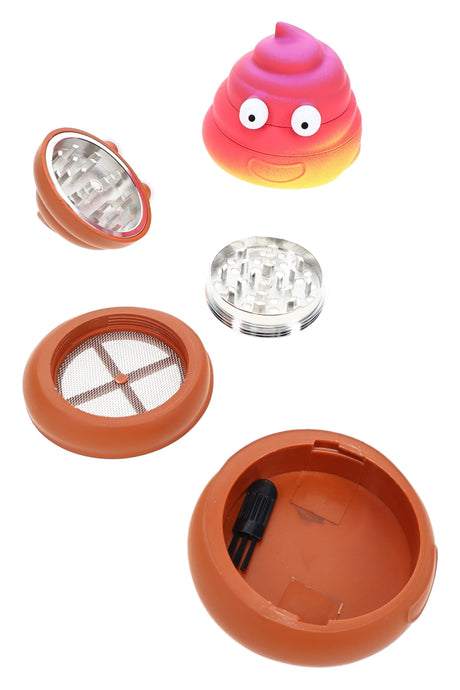 Exploded poop emoji herb grinder showing metal teeth, screen section, and compact 4-part design