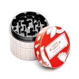 Open HEMPER Chinese Takeout grinder showing black grinding teeth beside its red illustrated lid