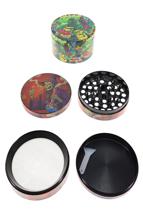 4-part metal herb grinder opened with black teeth, mesh screen, catch tray, and gray scraper