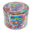 Colorful skull decal metal herb grinder with wraparound graffiti artwork and textured grip edge