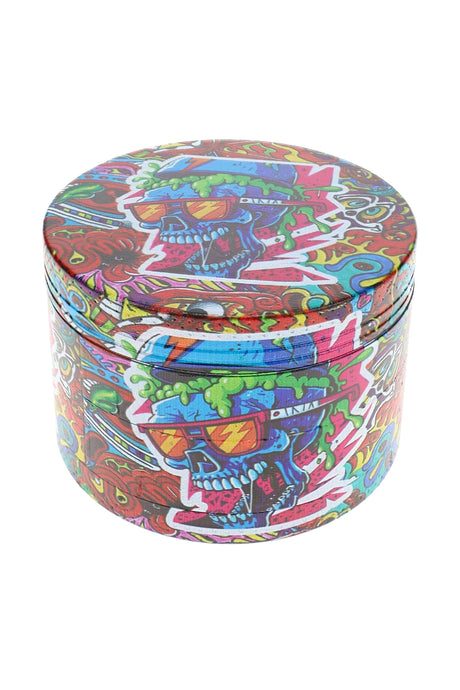 Colorful skull decal metal herb grinder with wraparound graffiti artwork and textured grip edge