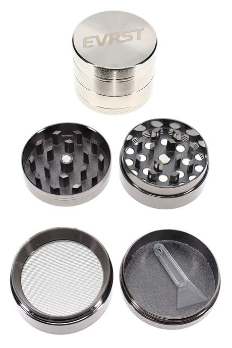 EVRST 4-part metal herb grinder opened with teeth, mesh screen, collection tray, and scraper