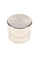 Polished EVRST metal herb grinder with engraved lid logo and textured grip bands