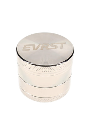 Polished EVRST metal herb grinder with engraved lid logo and textured grip bands