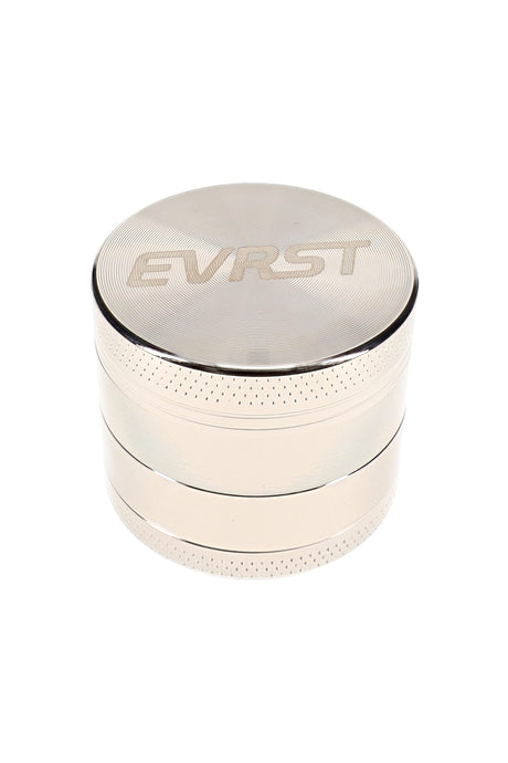 Polished EVRST metal herb grinder with engraved lid logo and textured grip bands
