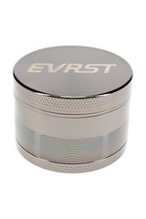 Gunmetal EVRST metal herb grinder close-up with engraved lid logo and knurled grip edge