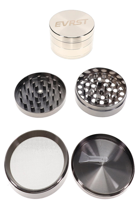EVRST 4-part metal herb grinder opened with black teeth, mesh screen, catch tray, and scraper