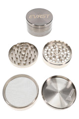 Large silver EVRST metal herb grinder close-up with engraved logo and textured grip bands
