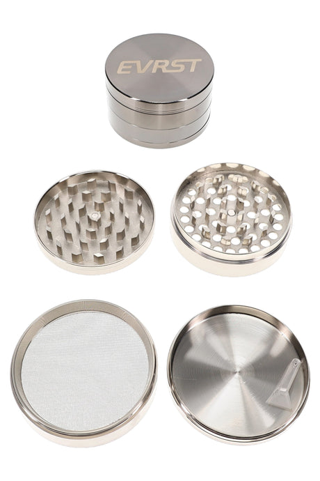 Large silver EVRST metal herb grinder close-up with engraved logo and textured grip bands
