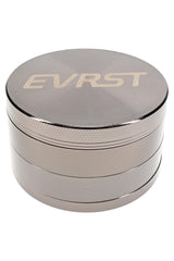 Polished silver EVRST herb grinder with engraved lid, stacked 4-part body, and grip texture