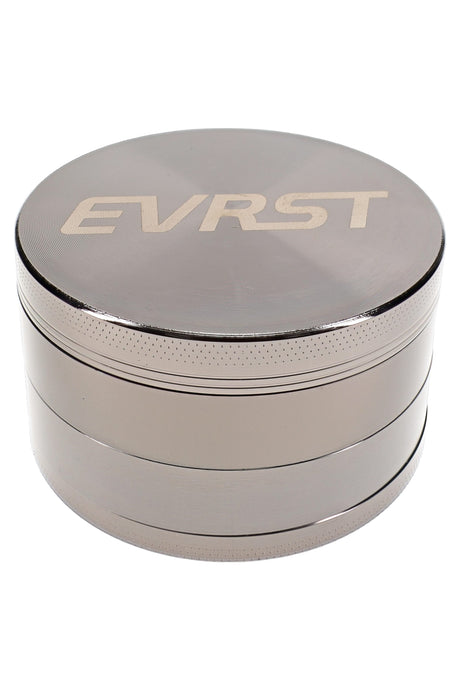 Polished silver EVRST herb grinder with engraved lid, stacked 4-part body, and grip texture