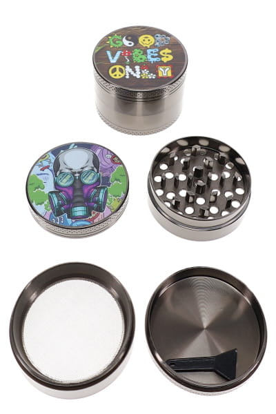 Open metal herb grinder set showing assorted decal lids, teeth, screen, chamber, and scraper