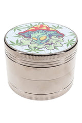 4-part metal herb grinder with mushroom alien decal lid and silver ribbed body on white background