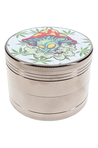4-part metal herb grinder with mushroom alien decal lid and silver ribbed body on white background