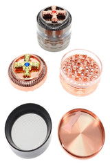 Open 4-part metal herb grinder showing teeth, screen, pollen chamber, scraper, and jeweled lids