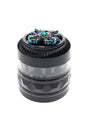Black 4-part metal herb grinder with clear window, rainbow rhinestone spinner top, and textured grip