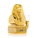 Angled side view of gold Hemper pharaoh glass bong with inline perc base and 14mm clear bowl on right side.