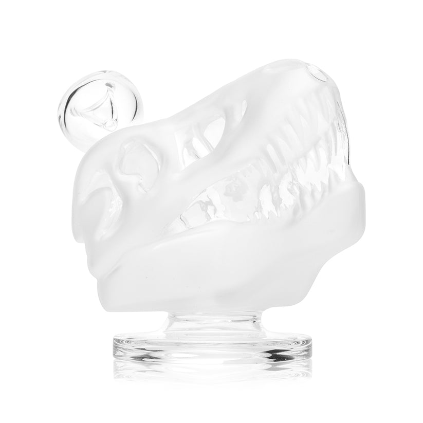 Close side profile of frosted T-rex skull Hemper glass bong showing detailed clear teeth, recessed 14.5 mm bowl joint and round base on white.