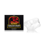 Side-by-side shot of Hemper Jurassic Spark skull hand pipe and branded box, highlighting compact dinosaur design for home smokers.