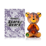 Front view of Hemper Scare Bears teddy bear hand pipe with amber frosted glass, black stitches and green logo foot on white.