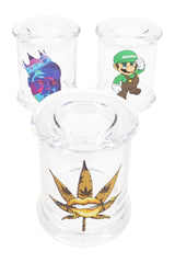 Three clear glass apothecary jars with random decals—weed leaf lips, crowned gorilla, Luigi parody—displayed on white background