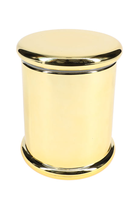 Polished gold colored glass jar, 4 inches tall, showing seamless cylindrical body and matching lid against white surface