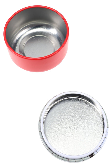 Interior view of red metal stash jar showing smooth food-grade steel lining beside matching printed lid, displayed on white backdrop